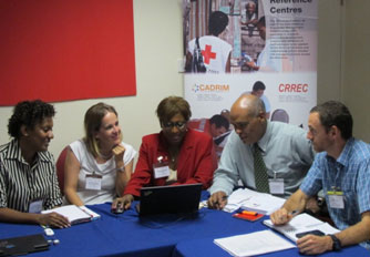 Far left: DONNA PIERRE ,CONSULTANT COORDINATOR, CDRMP , FOREIGN AFFAIRS, TRADE DEVELOPMENT CANADA (DFATD)/CDEMA Representative; Second from left: NATALIE HUTCHINSON,  SENIOR DEVELOPMENT OFFICER, Department for FOREIGN AFFAIRS, TRADE DEVELOPMENT CANADA (DFATD); Middle: LORRAINE MANGWIRO ,REGIONAL REPRESENTATIVE , IFRC – Caribbean Regional Representation Office; Second from right: LESLIE WALLING , PROJECT MANAGER COMMUNITY RISK REDUCTION FUND , CARIBBEAN DEVELOPMENT BANK; Far right: Richard McCabe, Senior Program Manager, Americas Unit, International Operations Canadian Red Cross